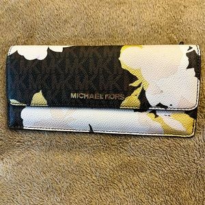 Like new Michael Kors wallet with 8 card holders and space for cash and change.